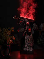 Guts Berserker Armor Mist Diffuser Figure – lit with mist in a room at night | Berserk