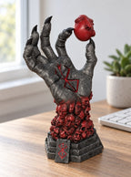 Demon Hand and Behelit Statue – on a desk | Berserk
